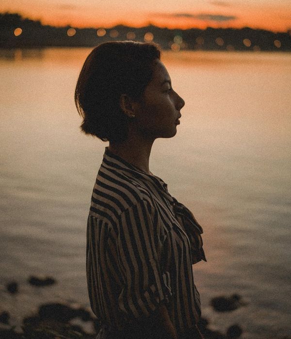 Person in a calm, balanced pose against a backdrop of nature.